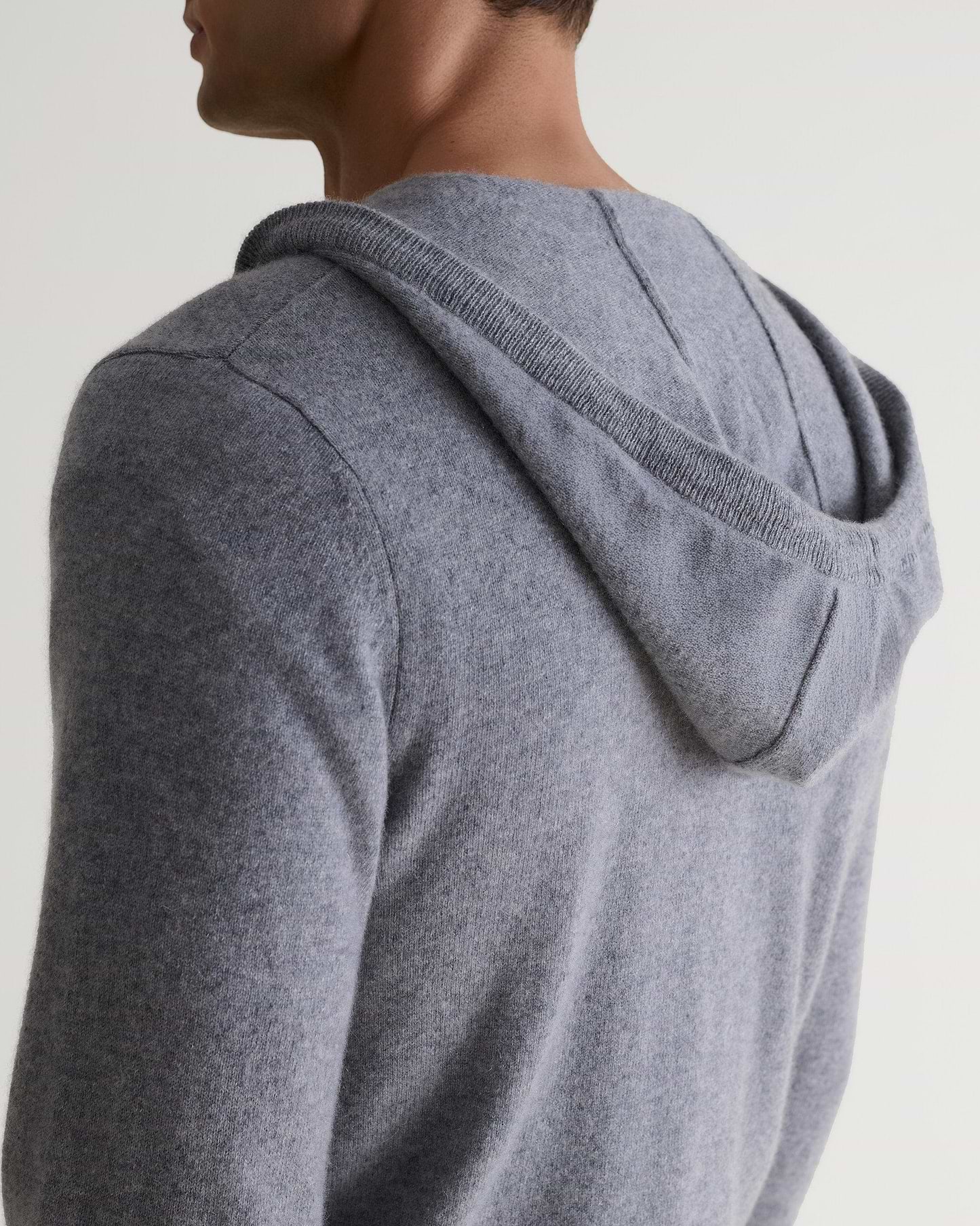 Image 6 of 6 showing man wearing Rise & Fall's fine cashmere zip hoodie, grey, back view.