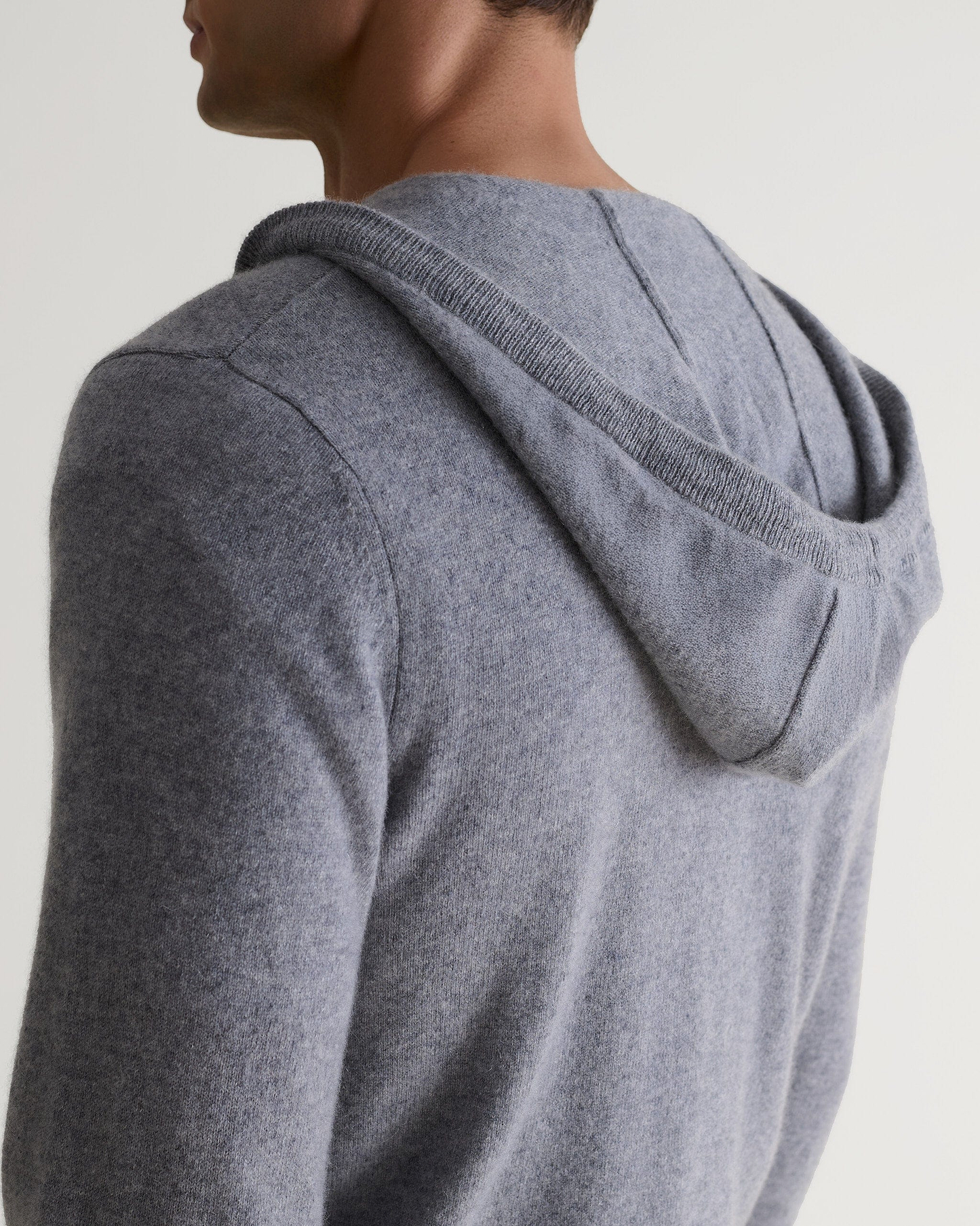 Image 6 of 6 showing man wearing Rise & Fall's fine cashmere zip hoodie, grey, back view.
