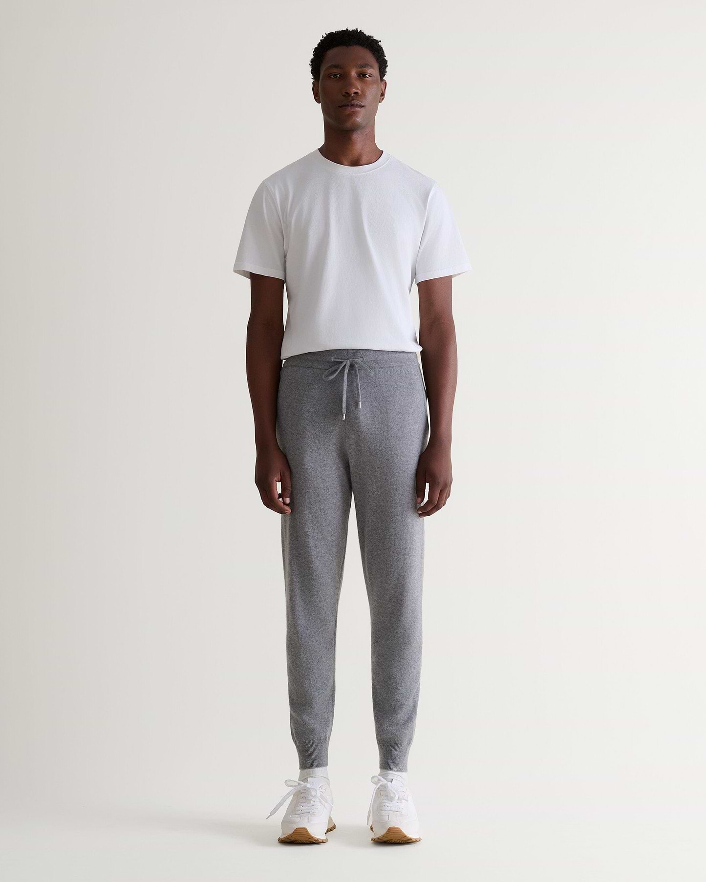 Image 6 of 6 showing man wearing Rise & Fall's fine cashmere joggers, grey.