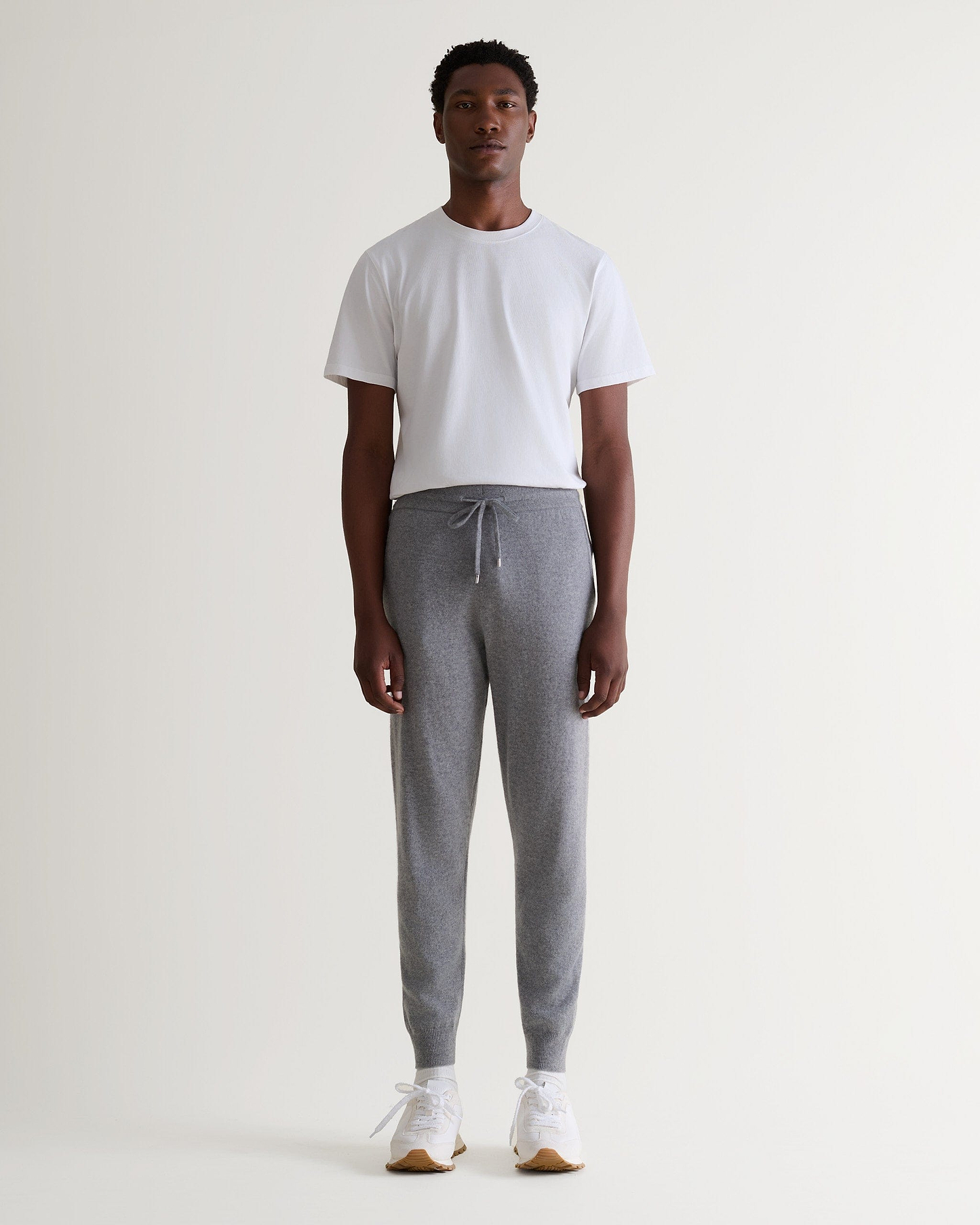 Image 6 of 6 showing man wearing Rise & Fall's fine cashmere joggers, grey.