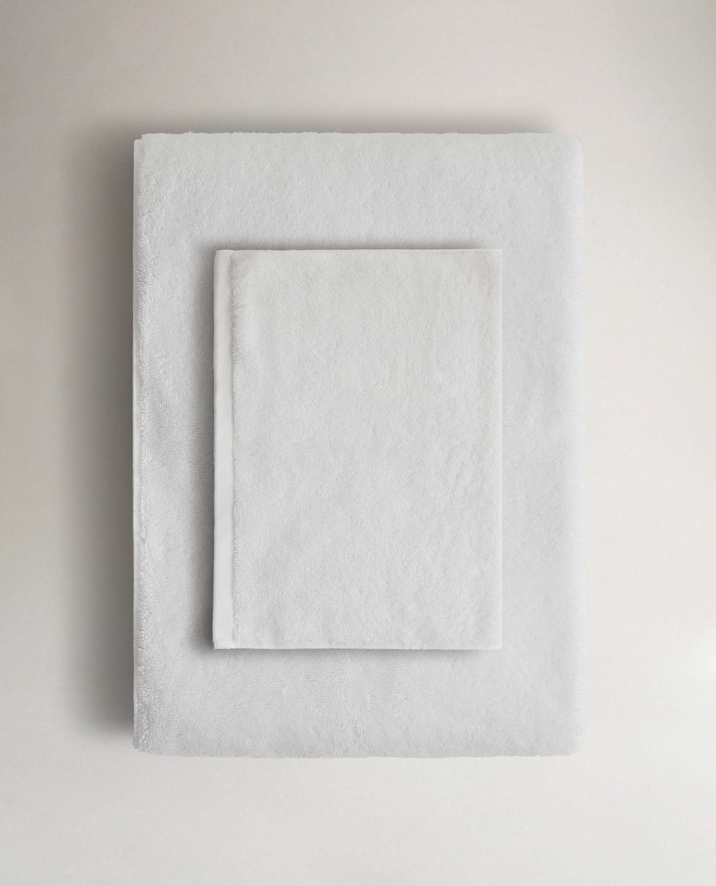 Rise & Fall's white Turkish cotton hand towel lying on top of matching bath towel