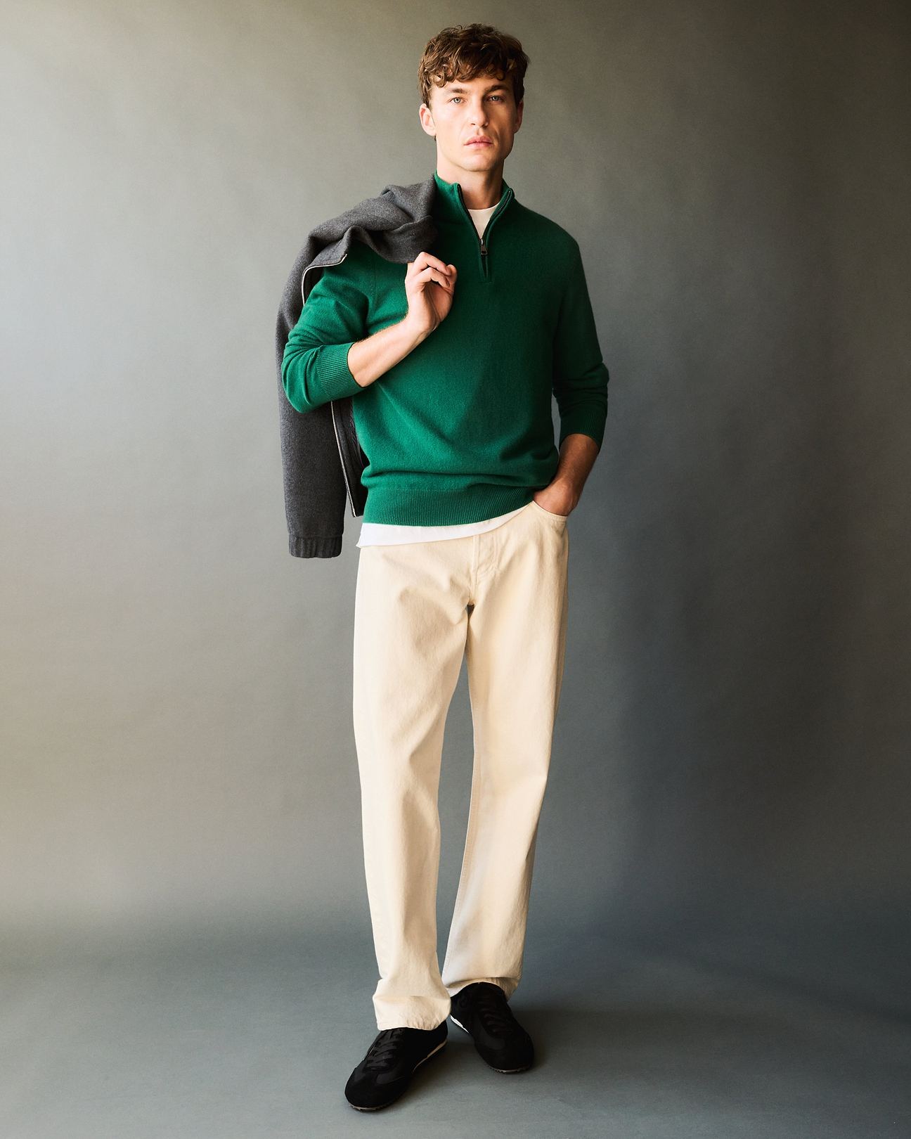Man wears Rise & Fall's Finest Cashmere 1/4 Zip Jumper in malachite green.