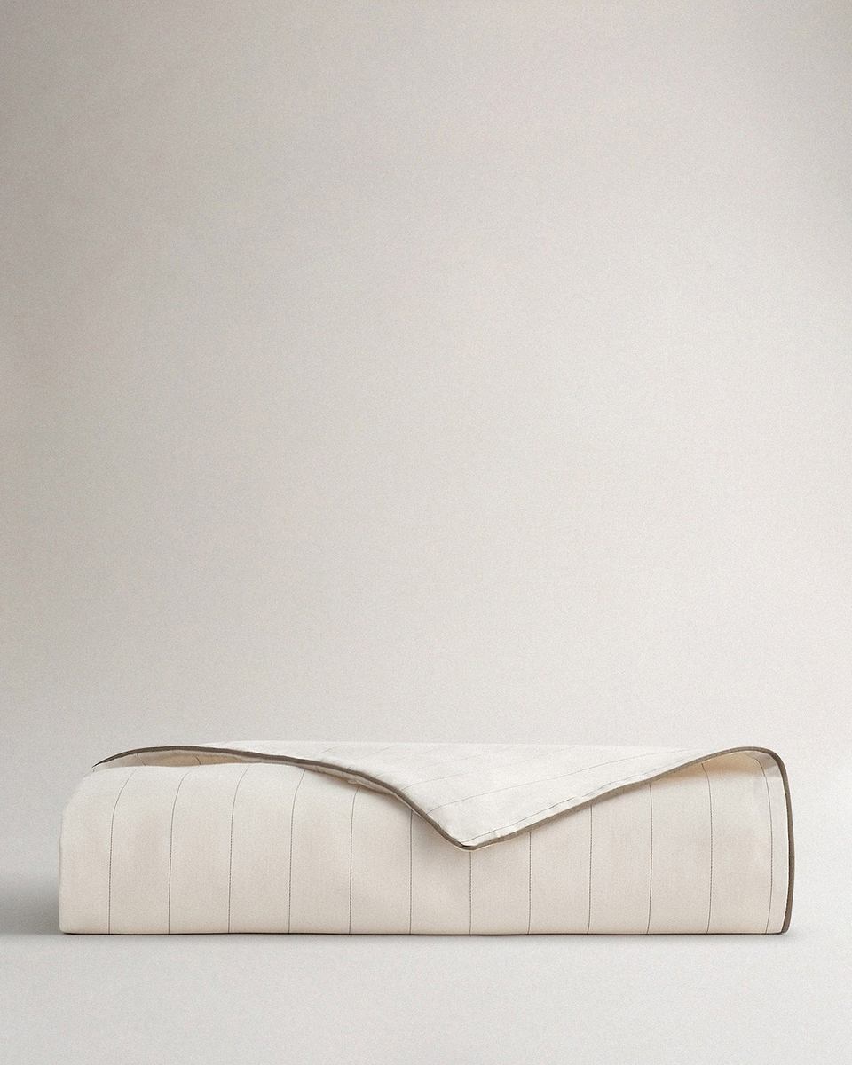 Image 1 of 2 showing Rise & Fall's sateen cotton duvet cover in buttermilk stripe.
