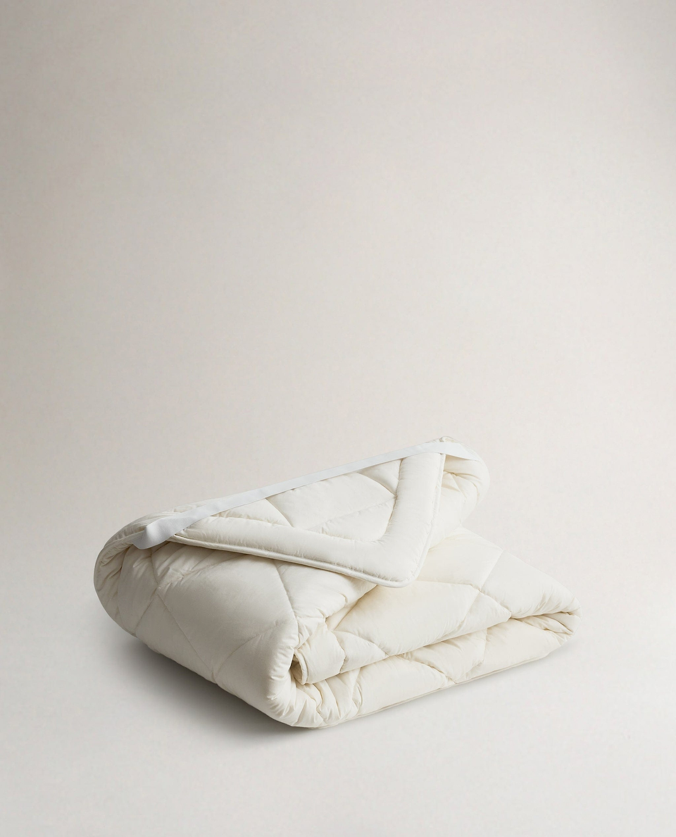 Image 1 of 2 showing Rise & Fall's  certified British Wool Mattress Topper.