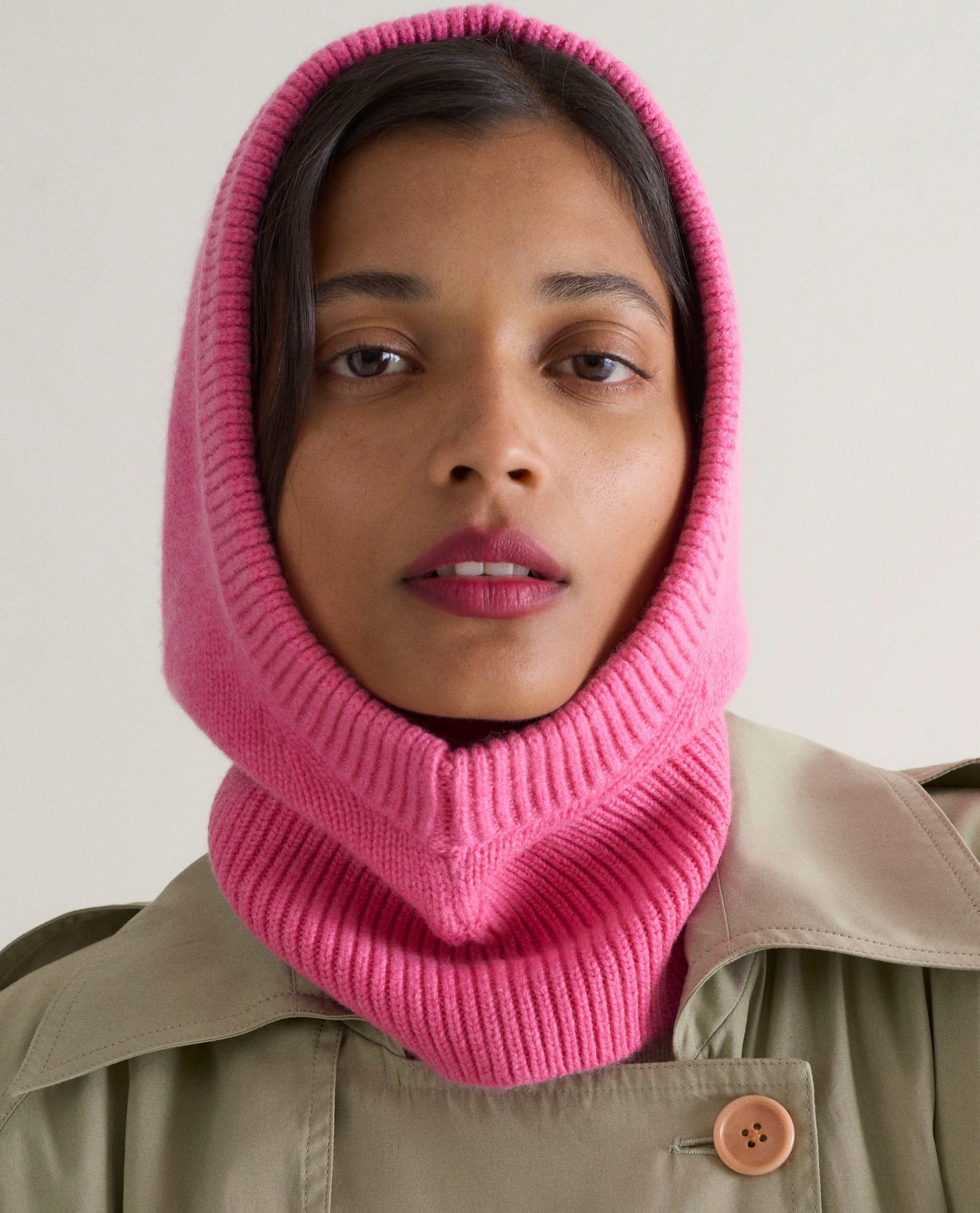 Image 1 of 2 showing woman wearing Rise & Fall's pink Cashmere Merino Knitted Hood.