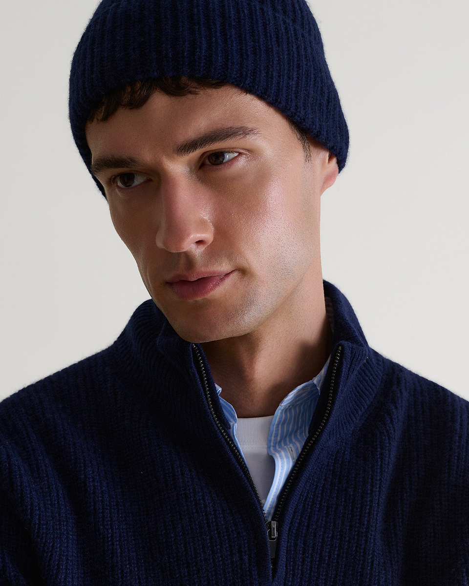Image 1 of 3 showing man wearing Rise & Fall's Cashmere Merino Ribbed Knit Beanie in navy.