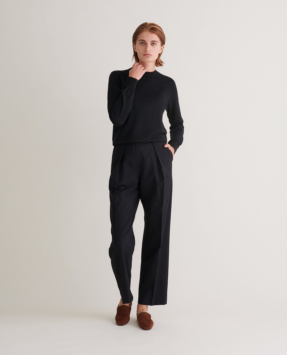 Image 1 of 3 showing woman wearing Rise & Fall's Finest Cashmere Classic Crew Neck Jumper in black.