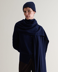 Image 1 of 3 showing woman wearing Rise & Fall's Cashmere Merino Ribbed Knit Beanie in indigo blue.
