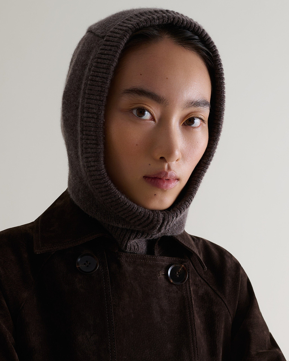 Image 1 of 4 showing woman wearing Rise & Fall's chocolate brown Cashmere Merino Knitted Hood.