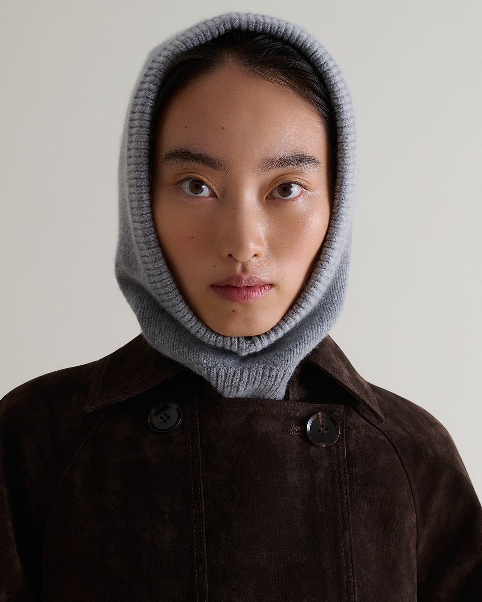 Image 1 of 4 showing woman wearing Rise & Fall's grey Cashmere Merino Knitted Hood.