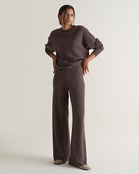 Image 1 of 4 showing woman wearing Rise & Fall's chocolate brown fine cashmere wide-leg trousers with matching cashmere sweatshirt.