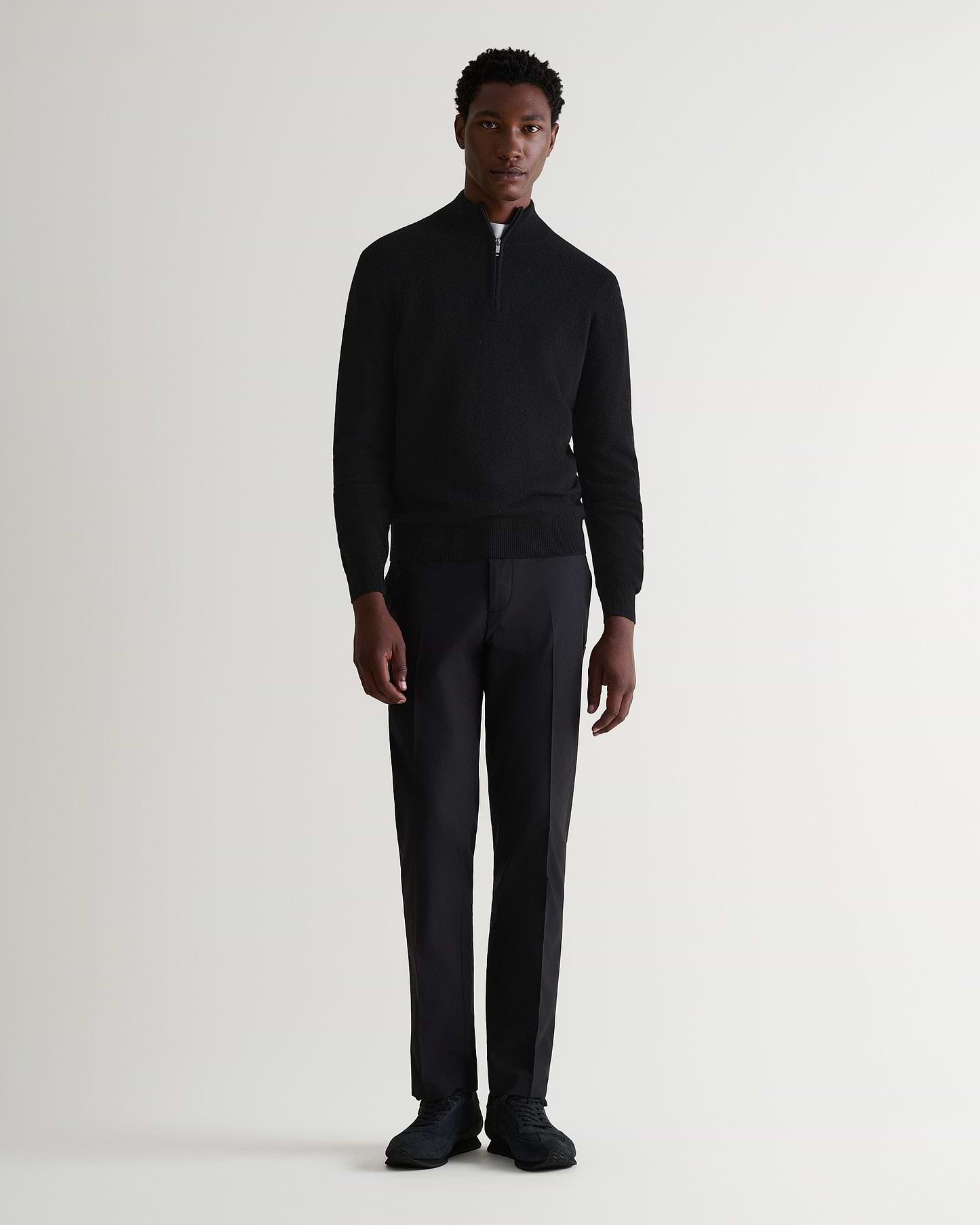 Image 1 of 5 showing man wearing Rise & Fall's fine cashmere 1/4 zip jumper, black