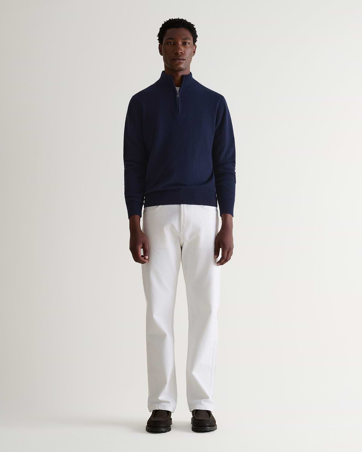 Image 1 of 5 showing man wearing Rise & Fall's fine cashmere 1/4 zip jumper, navy.