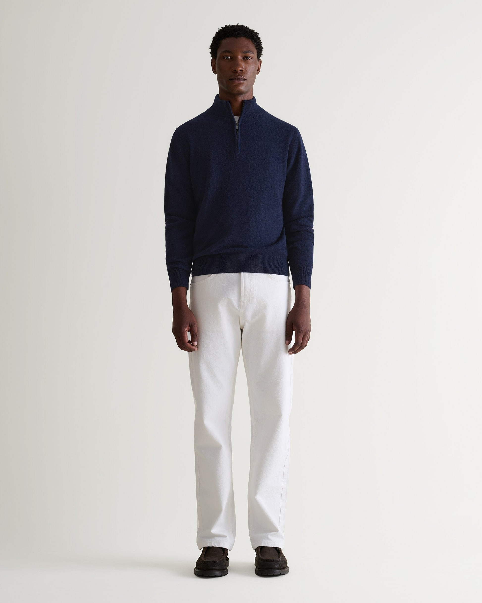 Image 1 of 5 showing man wearing Rise & Fall's fine cashmere 1/4 zip jumper, navy.
