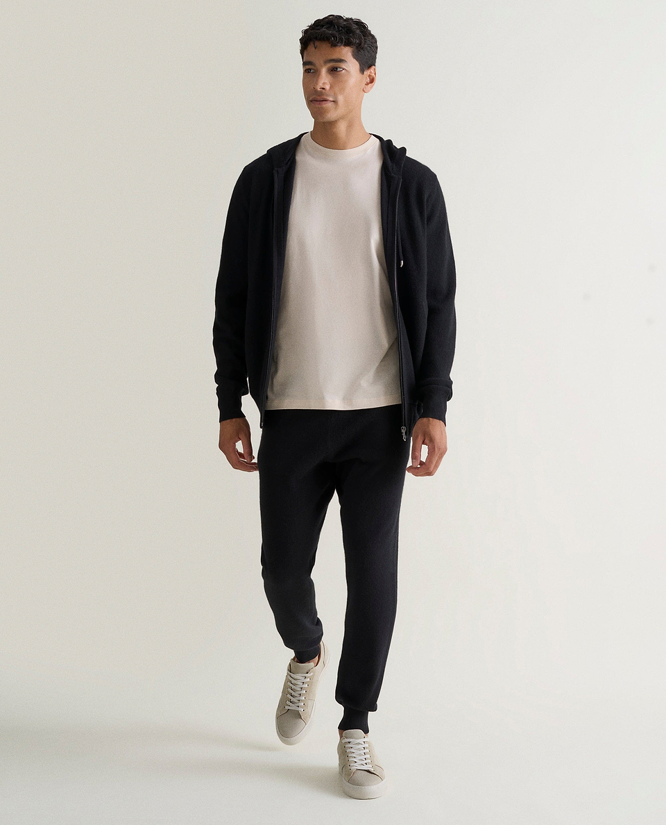 Image 1 of 5 showing man wearing Rise & Fall's fine cashmere joggers, black.