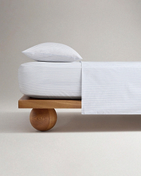 Image 1 of 5 showing Rise & Fall's Crisp & Cool organic percale cotton flat bed sheet in blue ticking stripe.