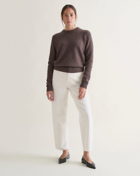 Image 1 of 5 showing woman wearing Rise & Fall's brown mid-weight cashmere crew neck jumper with white jeans.