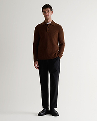 Image 1 of 6 of man wearing Rise & Fall's burl brown cashmere merino fisherman ribbed polo with black trousers and black shoes