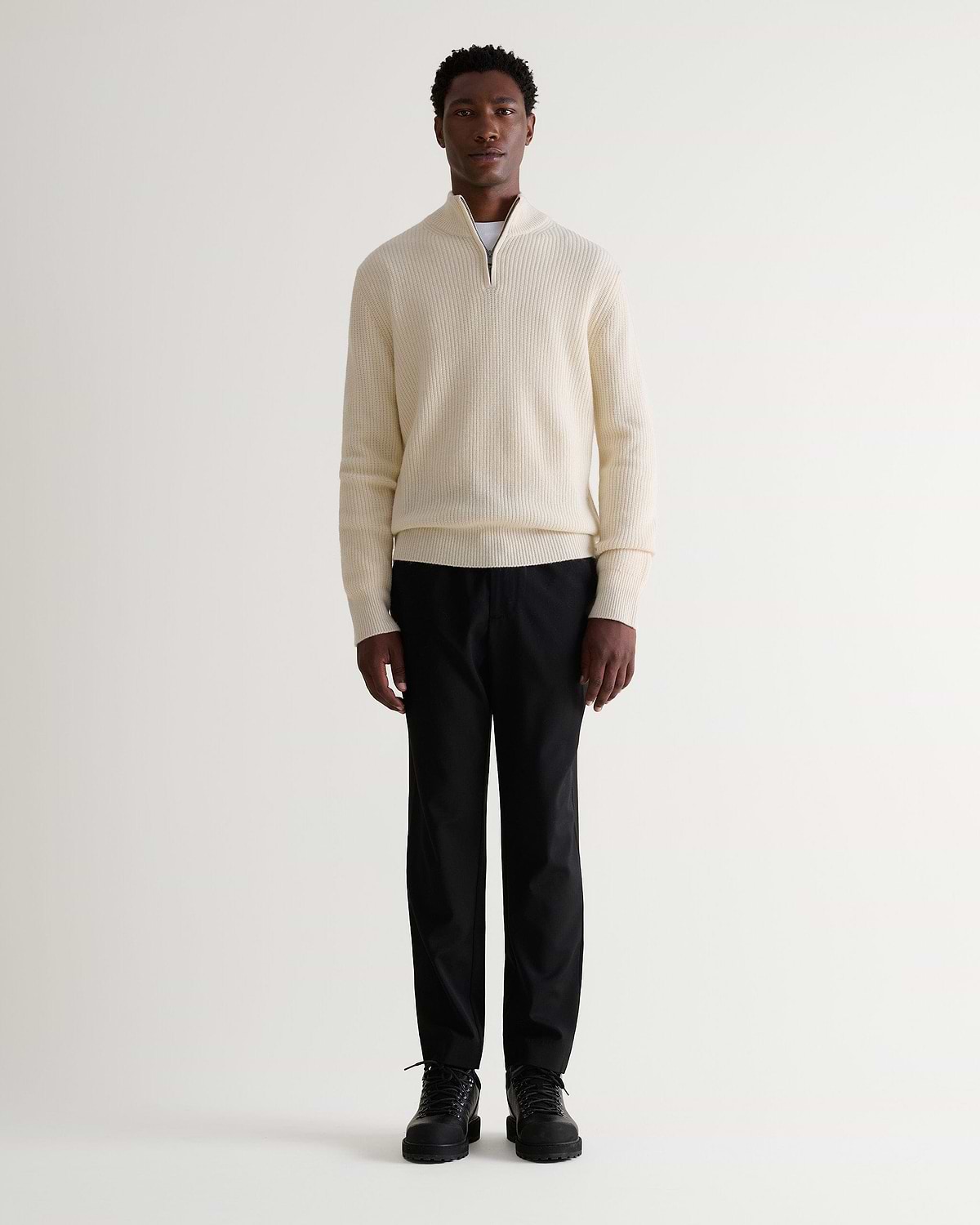 Image 1 of 6 showing man wearing Rise & Fall's Cashmere Merino Fishermans Rib 1/4 Zip Jumper in cream.
