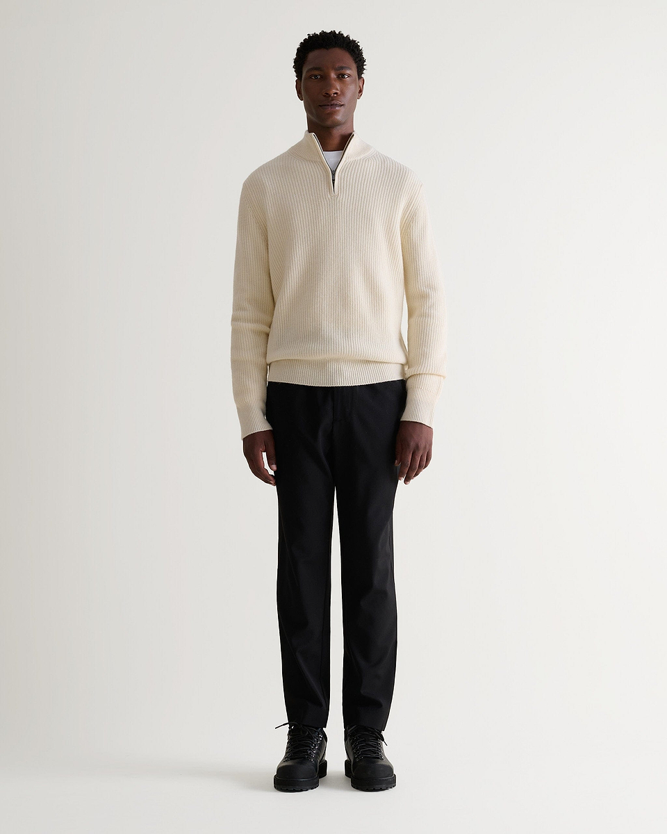 Image 1 of 6 showing man wearing Rise & Fall's Cashmere Merino Fishermans Rib 1/4 Zip Jumper in cream.