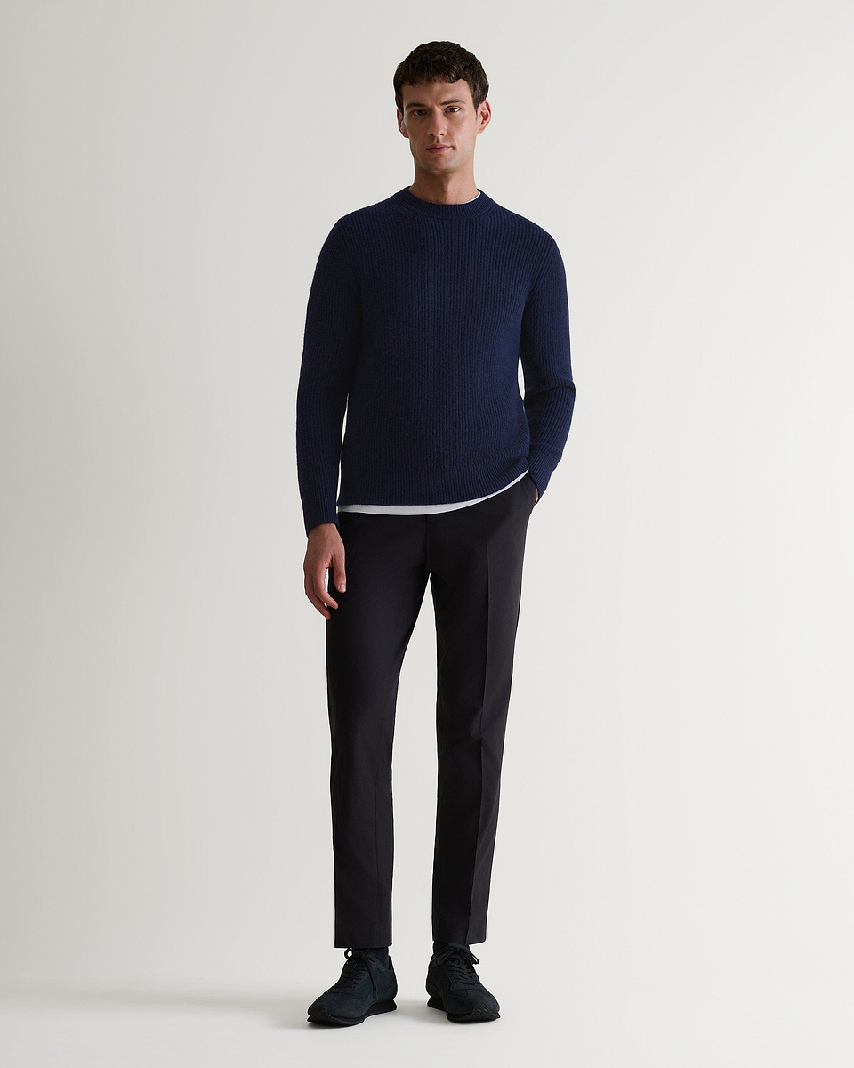 Image 1 of 6 showing man wearing Rise & Fall's Cashmere Merino Fishermans Rib Crew Neck Jumper in navy.