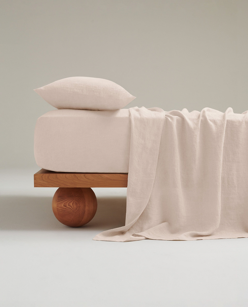 Image 1 of 6 showing Rise & Fall's Relaxed & Refined linen flat sheet in pale peach.