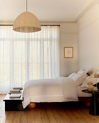 image 2 of 3 showing a bed made with Rise & Fall's Crisp & Cool duvet set, colour: white tailored border, fabric: percale cotton
