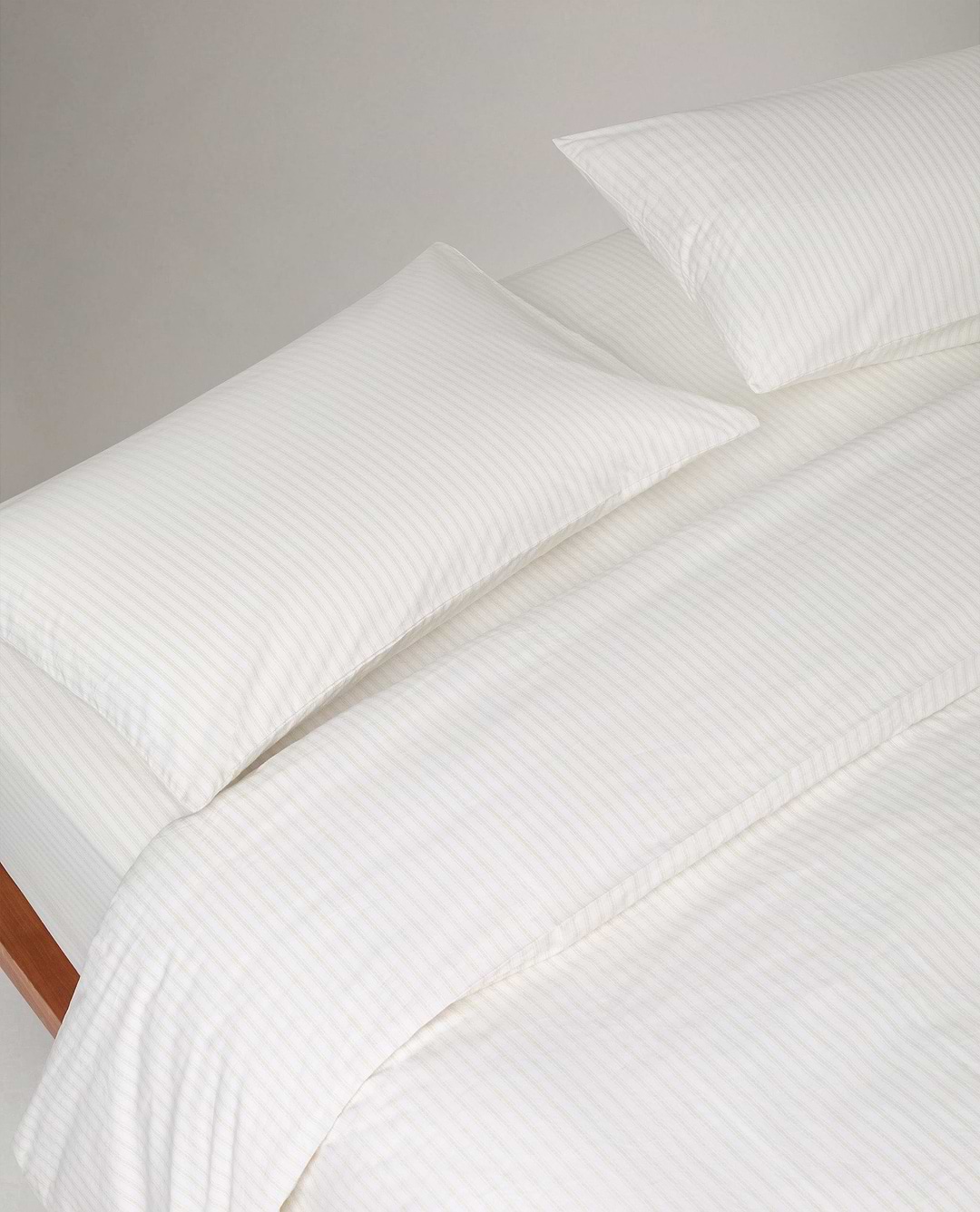 Image 2 of 3 showing Rise & Fall's Crisp & Cool Organic Cotton Pillowcases Set, colour: Buttermilk Ticking Stripe.