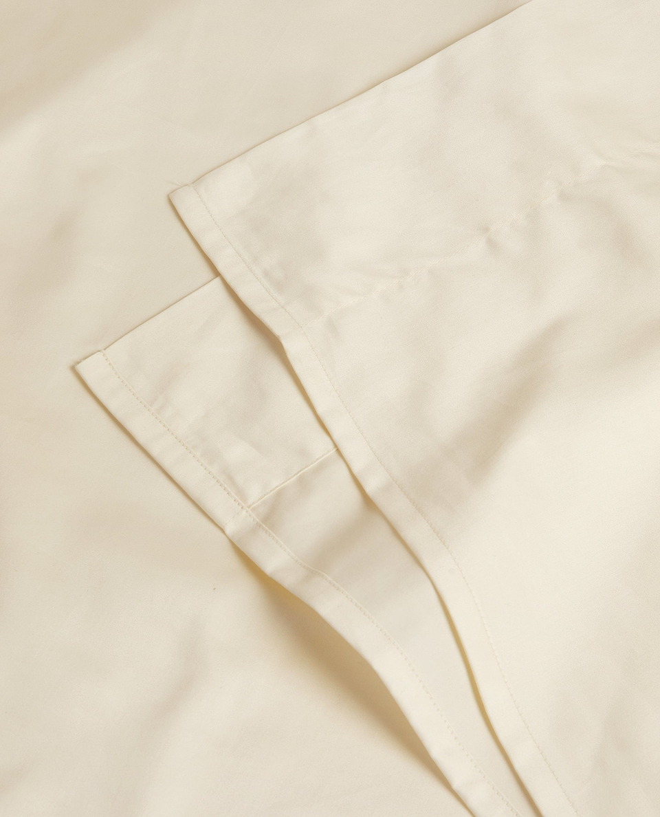 Image 2 of 3 showing Rise & Fall's Soft & Smooth sateen cotton flat sheet in buttermilk.