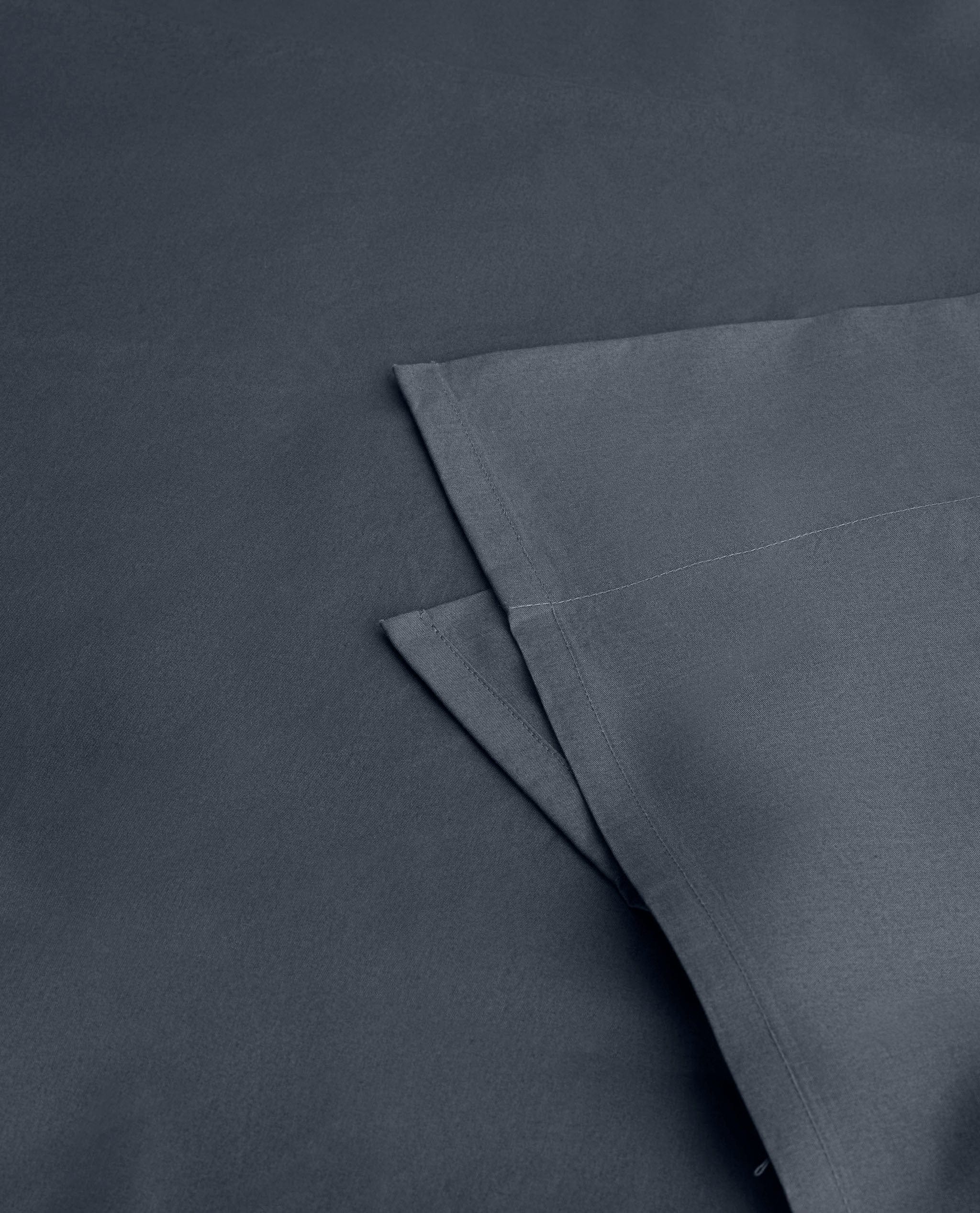 Image 2 of 4 showing Rise & Fall's Soft & Smooth organic sateen cotton flat sheet in mood indigo. 