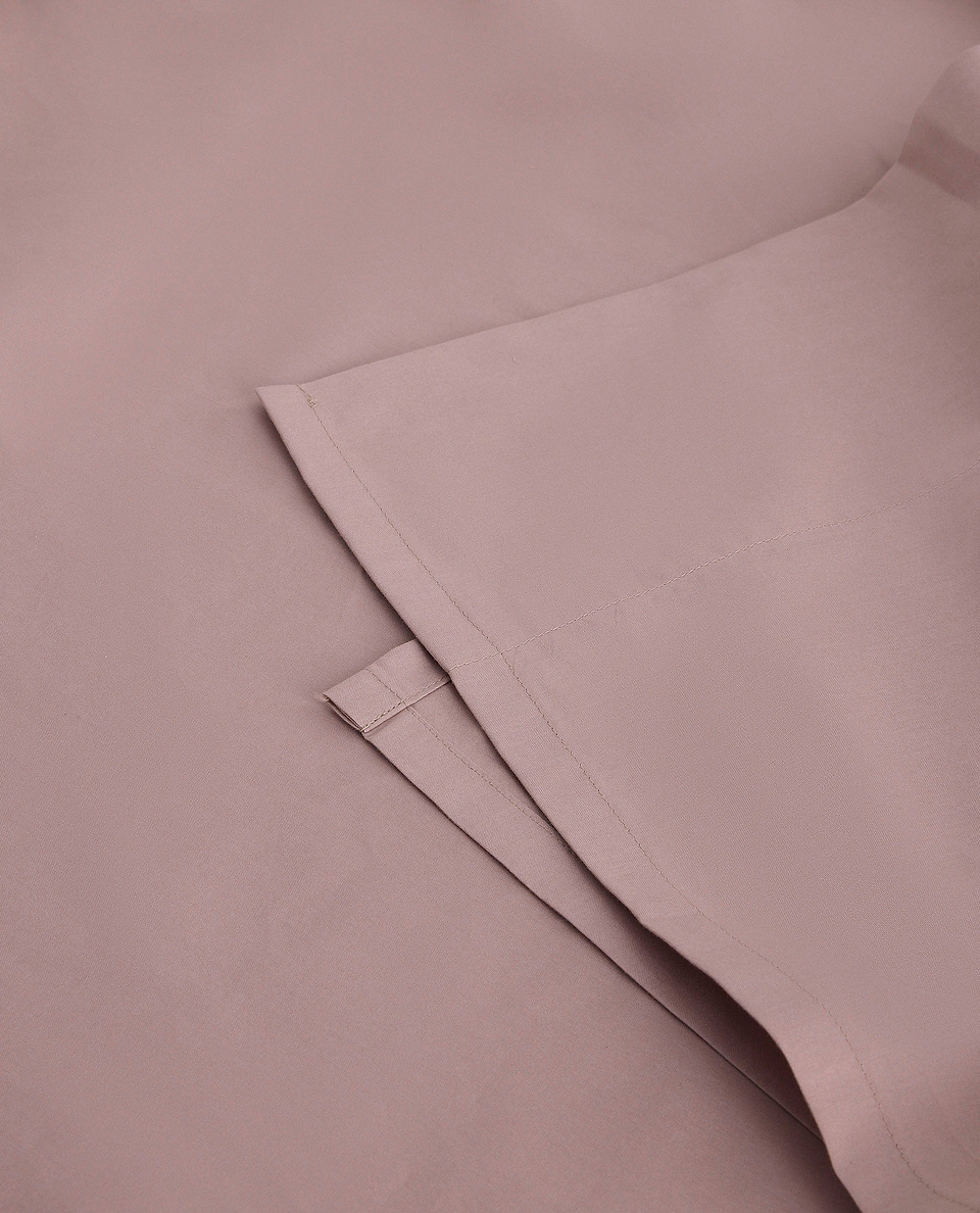 Image 2 of 4 showing Rise & Fall's Soft & Smooth organic sateen cotton flat sheet in deep clay.