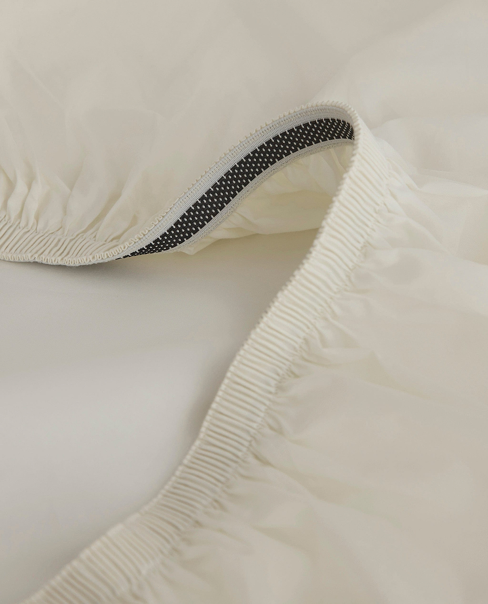 Image 2 of 5 showing Rise & Fall's buttermilk Soft & Smooth sateen cotton deep fitted sheet.