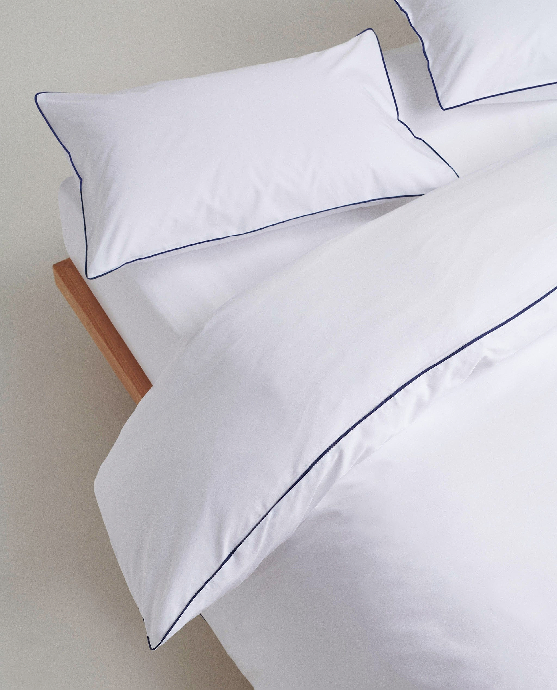 Image 2 of 5 showing Rise & Fall's percale cotton duvet cover, colour: white navy piping.