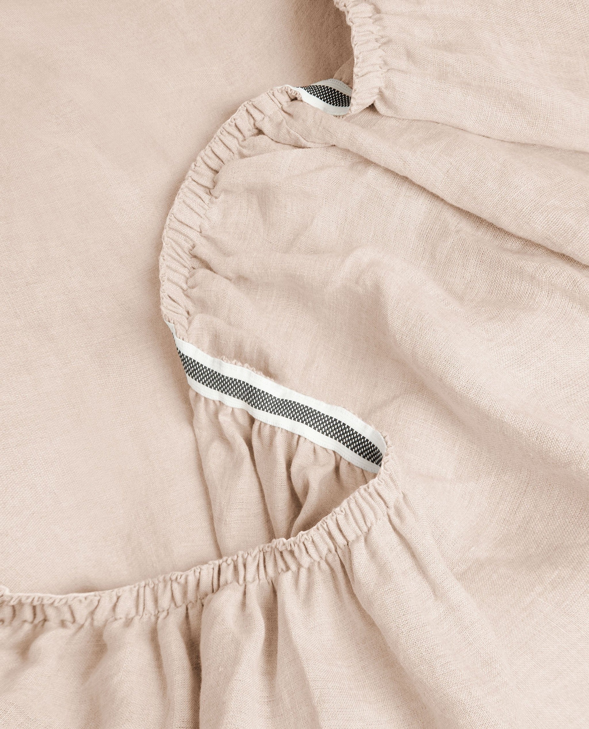 Image 2 of 6 showing Rise & Fall's House of Grey European Flax™ linen fitted sheet in peach.