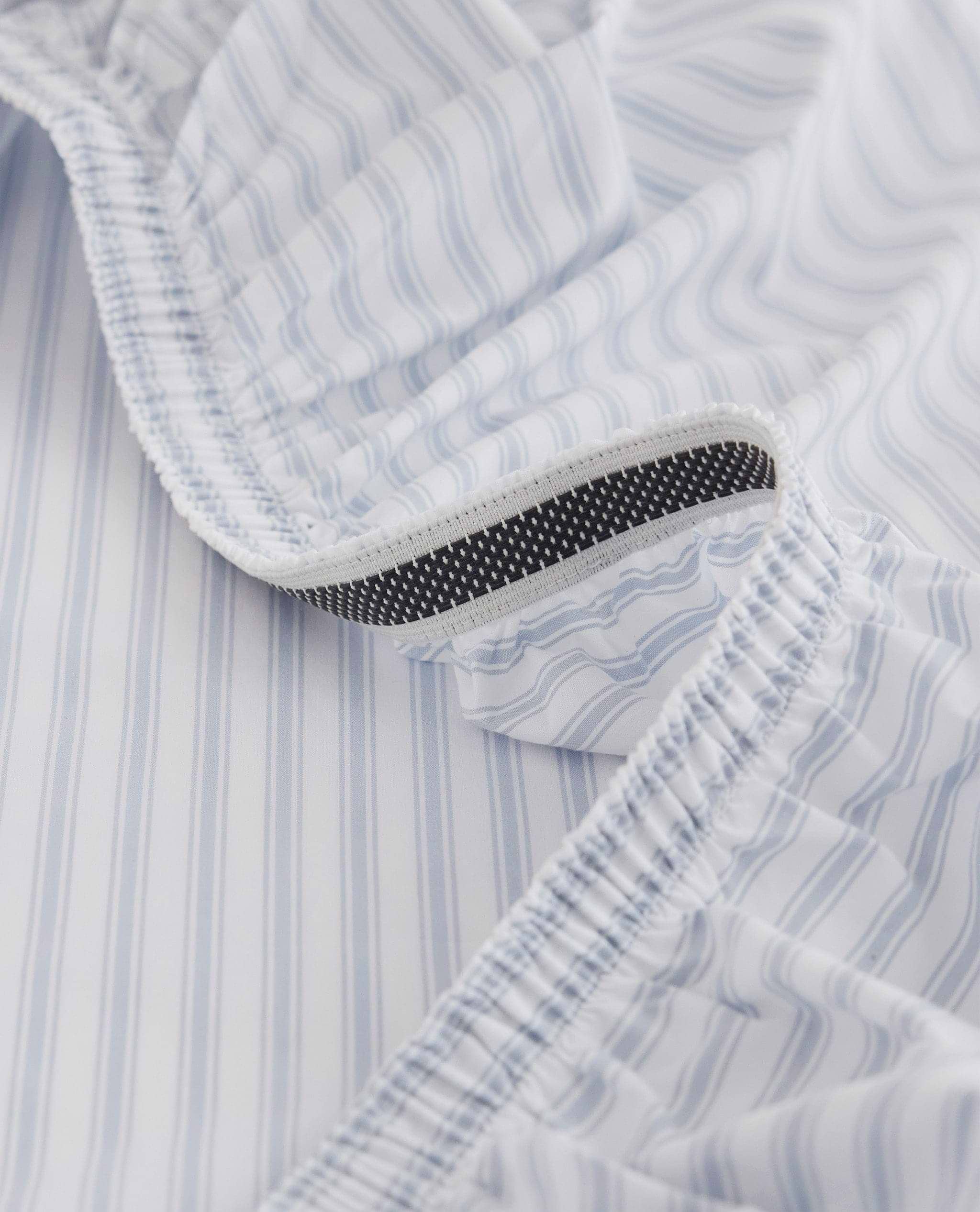 Image 2 of 6 showing Rise & Fall's Crisp & Cool organic cotton fitted bed sheet in blue stripe ticking.
