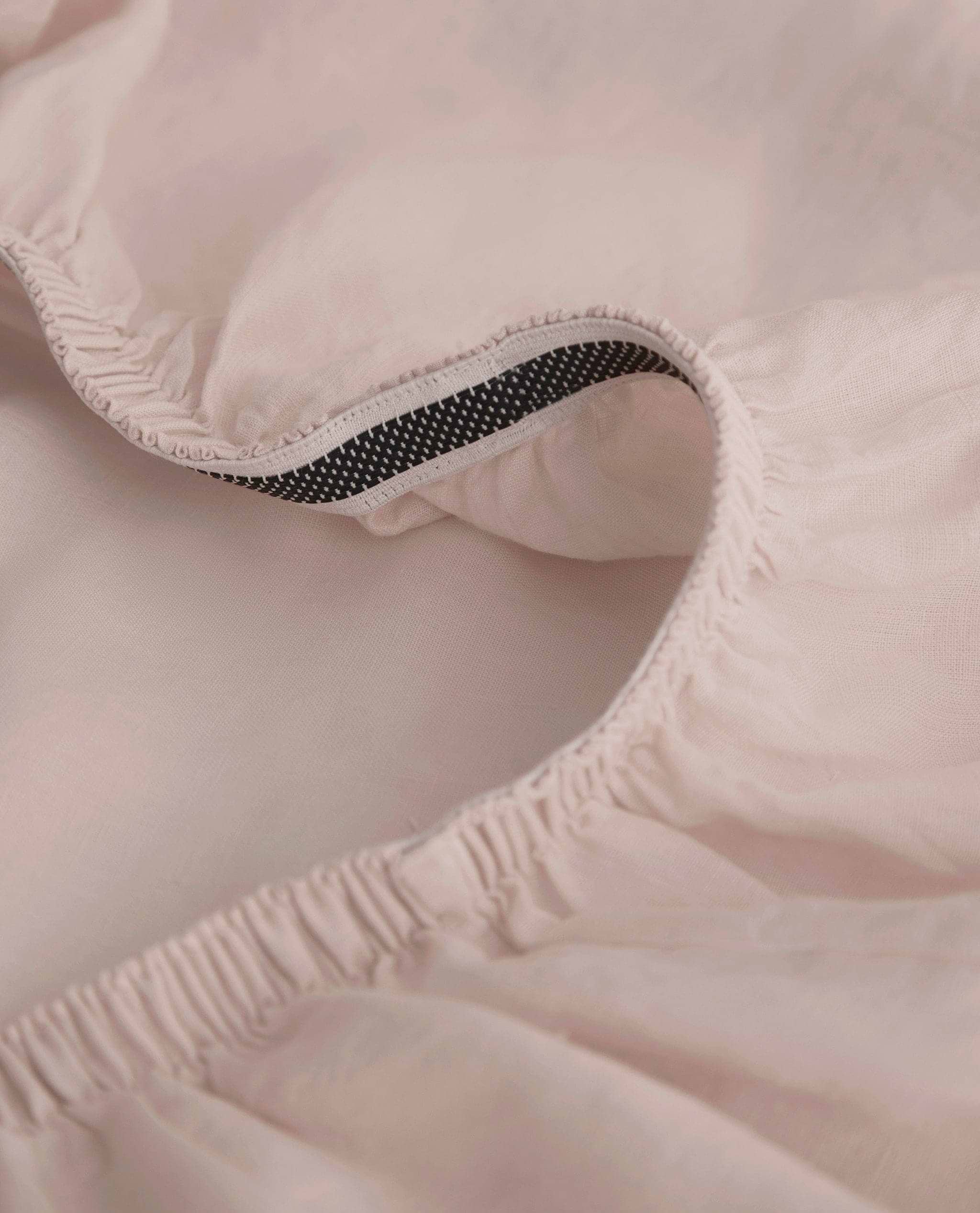 Image 2 of 8 showing Rise & Fall's Relaxed & Refined European flax™ linen fitted sheet in peach.