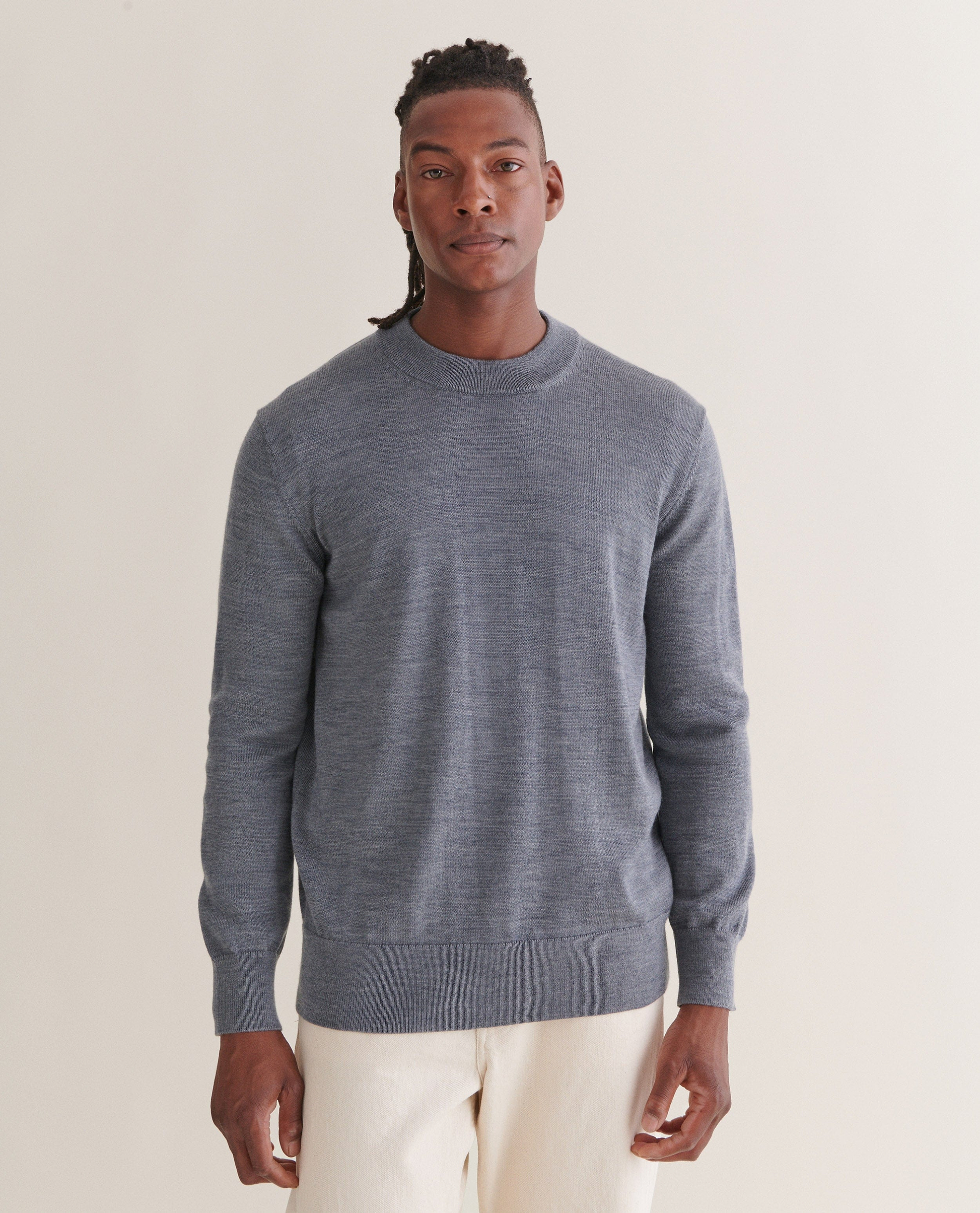 Image 3 of 4 showing man wearing Rise & Fall's merino mid-weight crew neck jumper in grey.