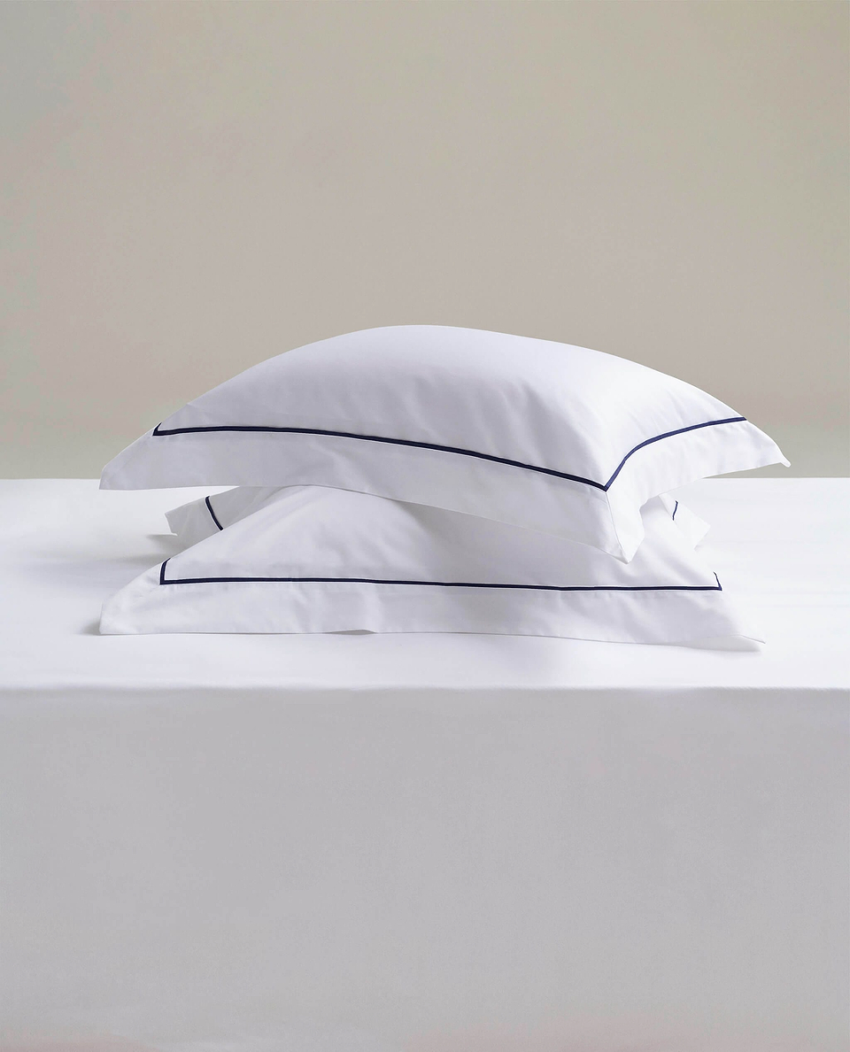 Image 3 of 4 showing Rise & Fall's Soft & Smooth Cotton Sateen Oxford Pillowcase Set in white navy piping.