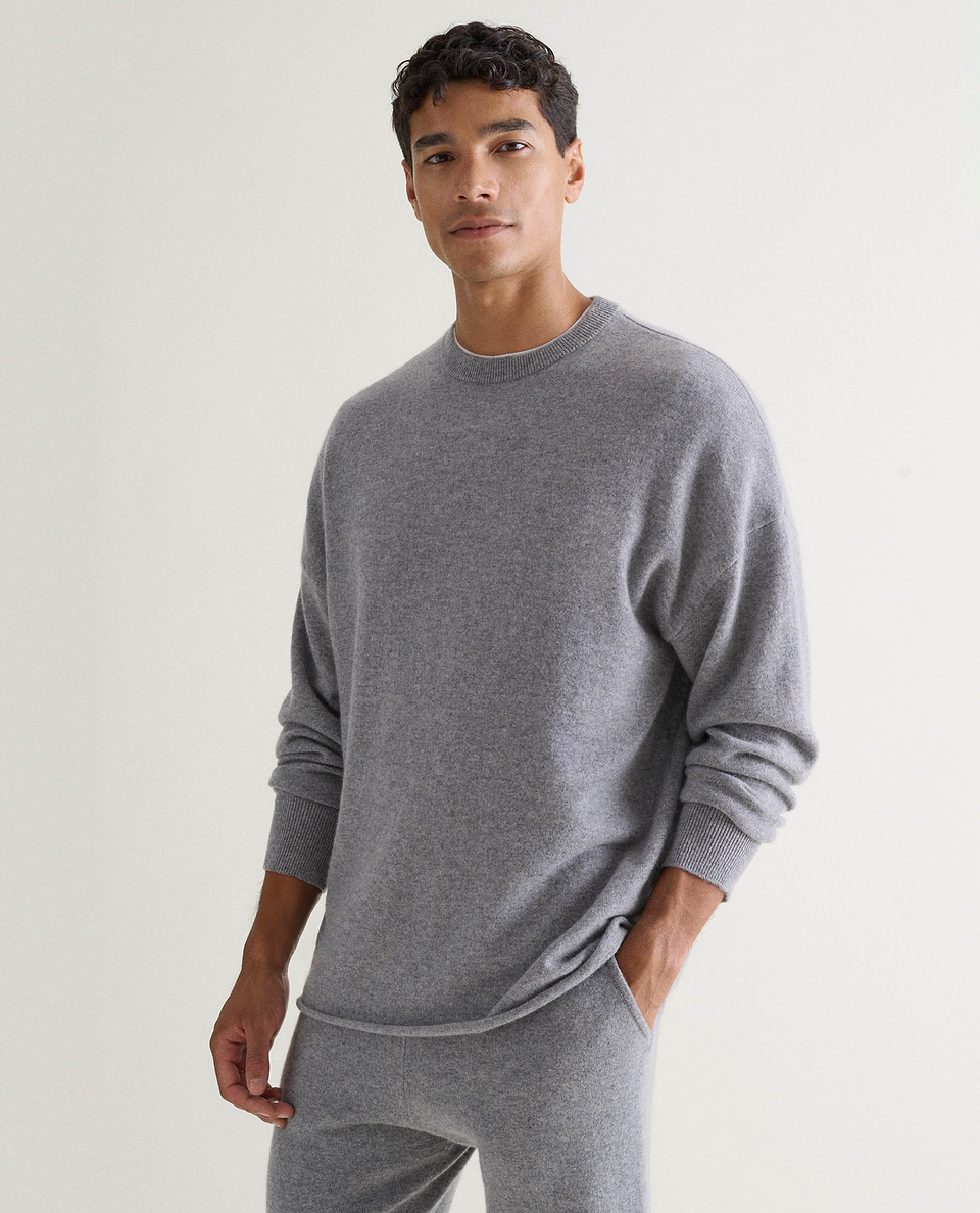 Image 3 of 5 showing man wearing Rise & Fall's finest cashmere sweatshirt in grey with matching joggers.