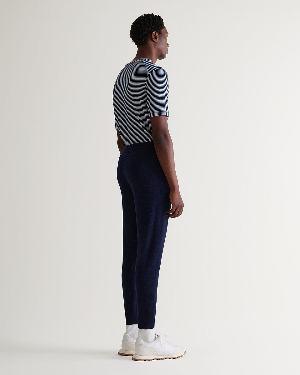Image 3 of 5 showing man wearing Rise & Fall's fine cashmere jogger, navy.