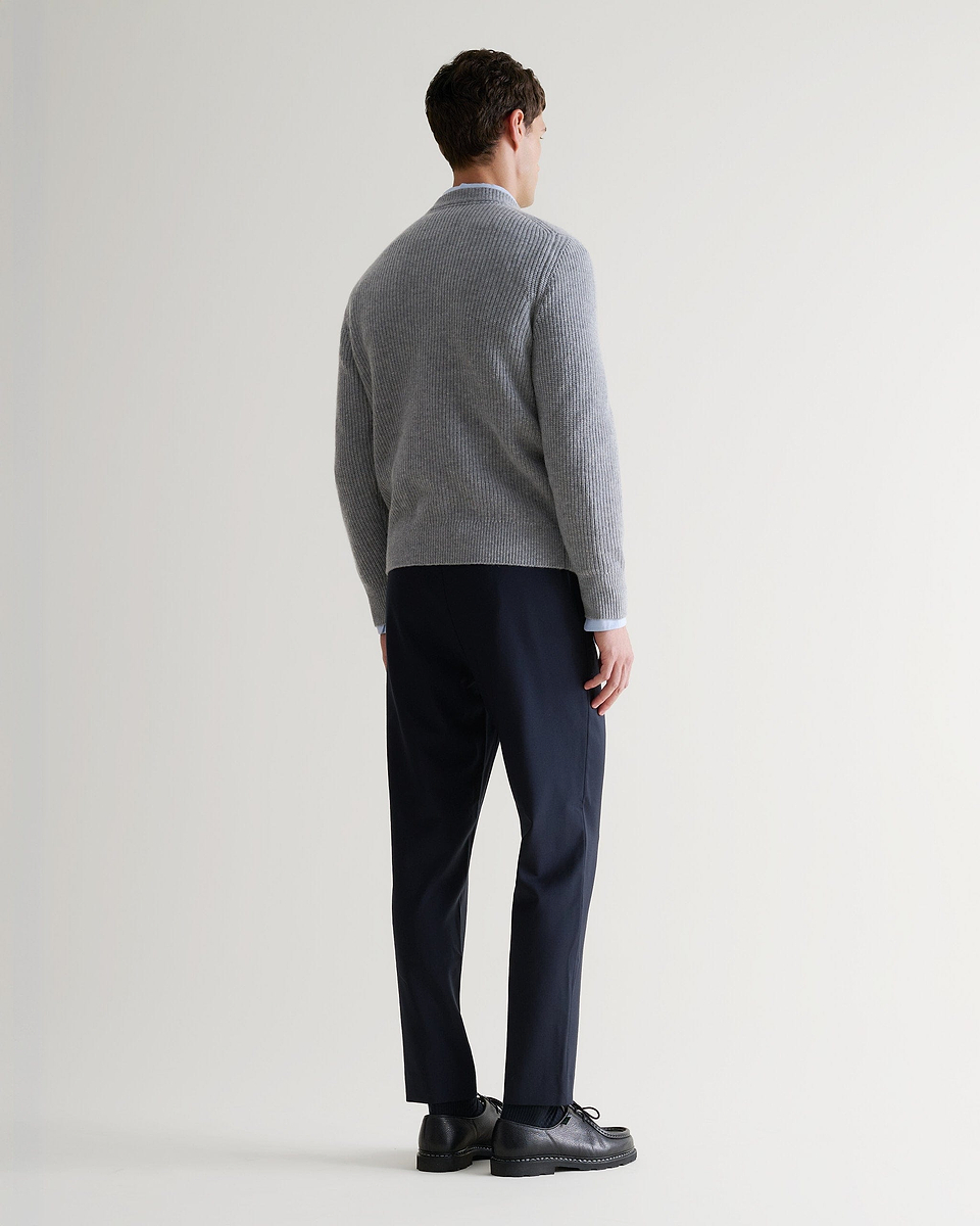 Image 3 of 5 showing back of man wearing Rise & Fall's Cashmere Merino Fishermans Rib Crew Neck Jumper in grey.