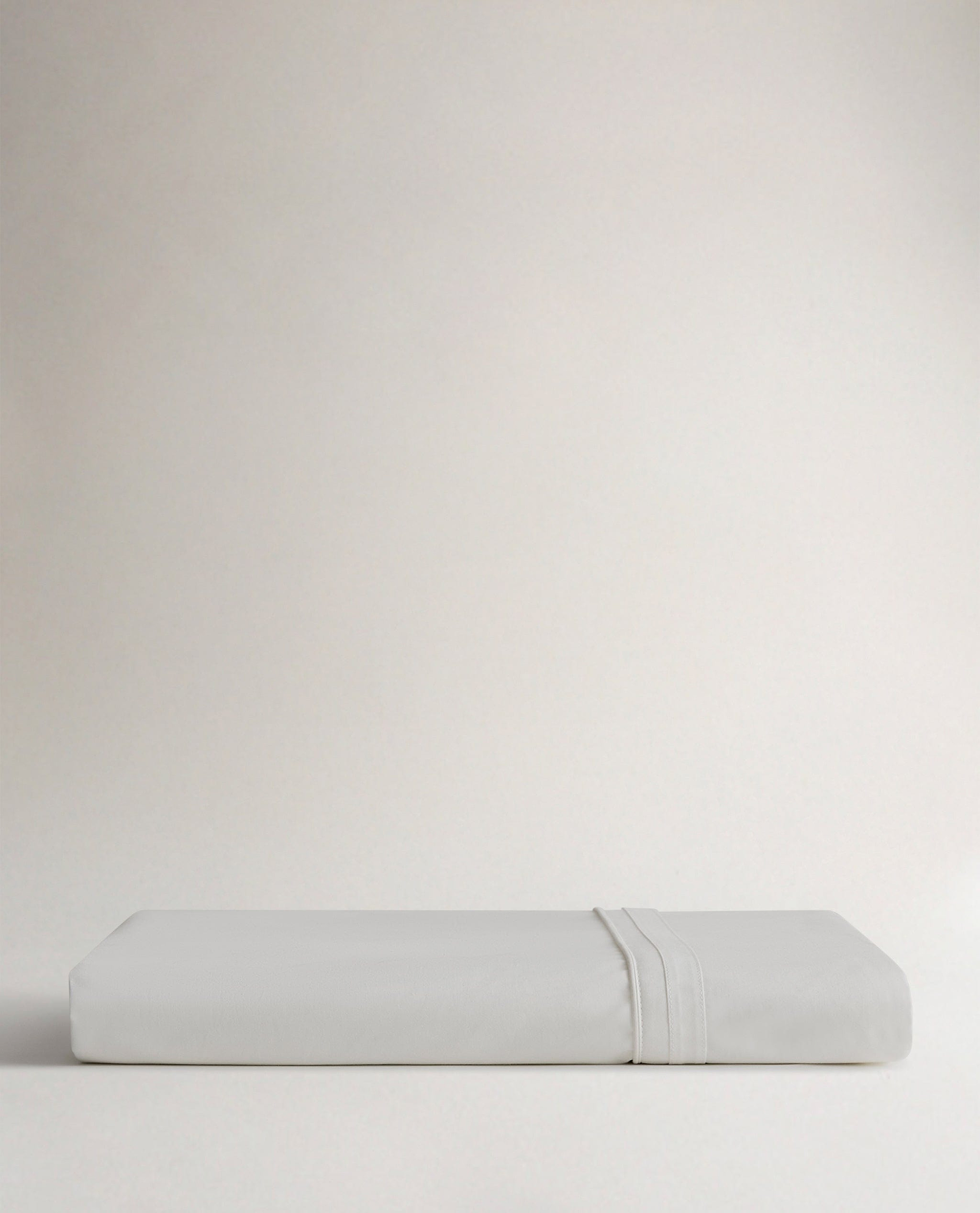 Image 3 of 5 showing Rise & Fall's Crisp & Cool organic percale cotton flat bed sheet in white tailored border.