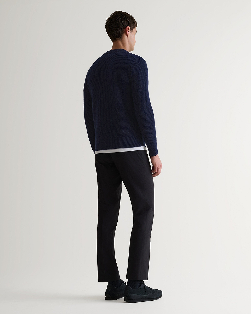 Image 3 of 6 showing back of man wearing Rise & Fall's Cashmere Merino Fishermans Rib Crew Neck Jumper in navy.