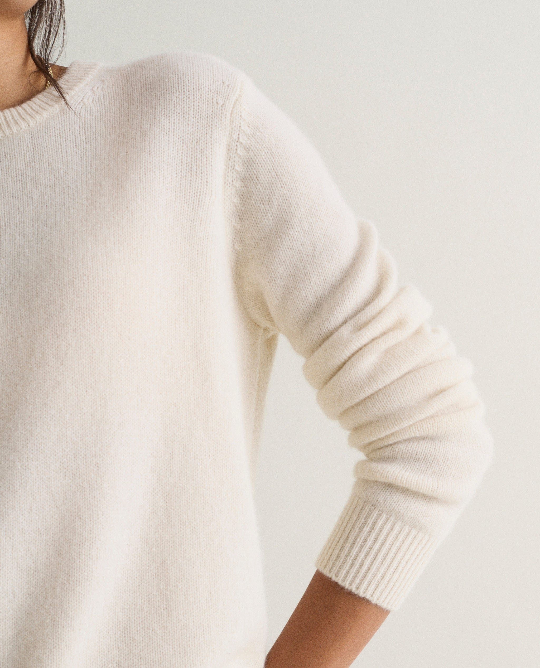 Image 4 of 5 showing a close up of Rise & Fall's cream mid-weight cashmere crew neck jumper.