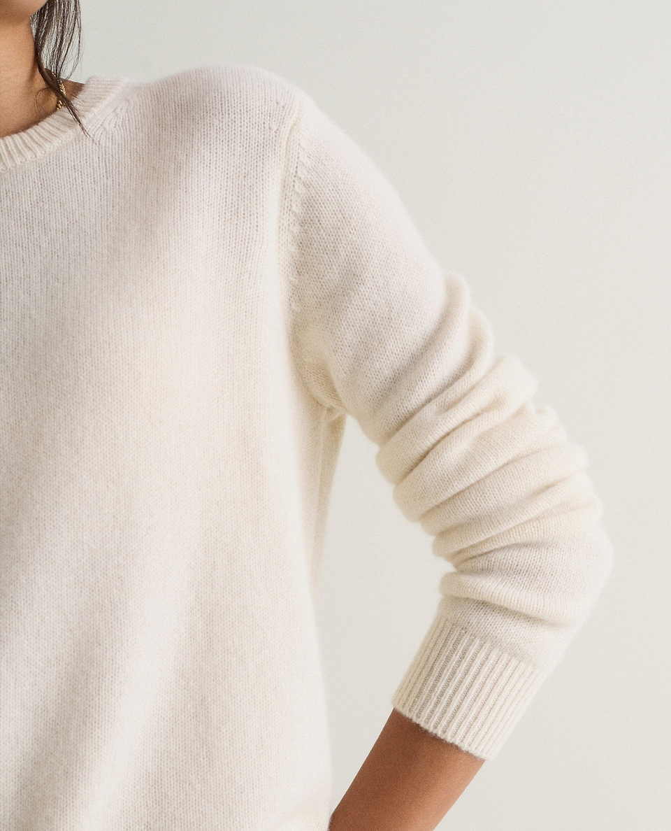 Image 4 of 5 showing a close up of Rise & Fall's cream mid-weight cashmere crew neck jumper.