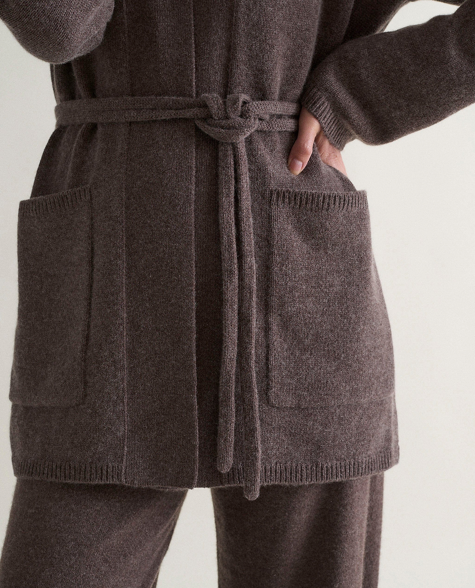 Image 4 of 6 showing close up of Rise & Fall's brown cashmere merino belted cardigan with matching cashmere trousers.