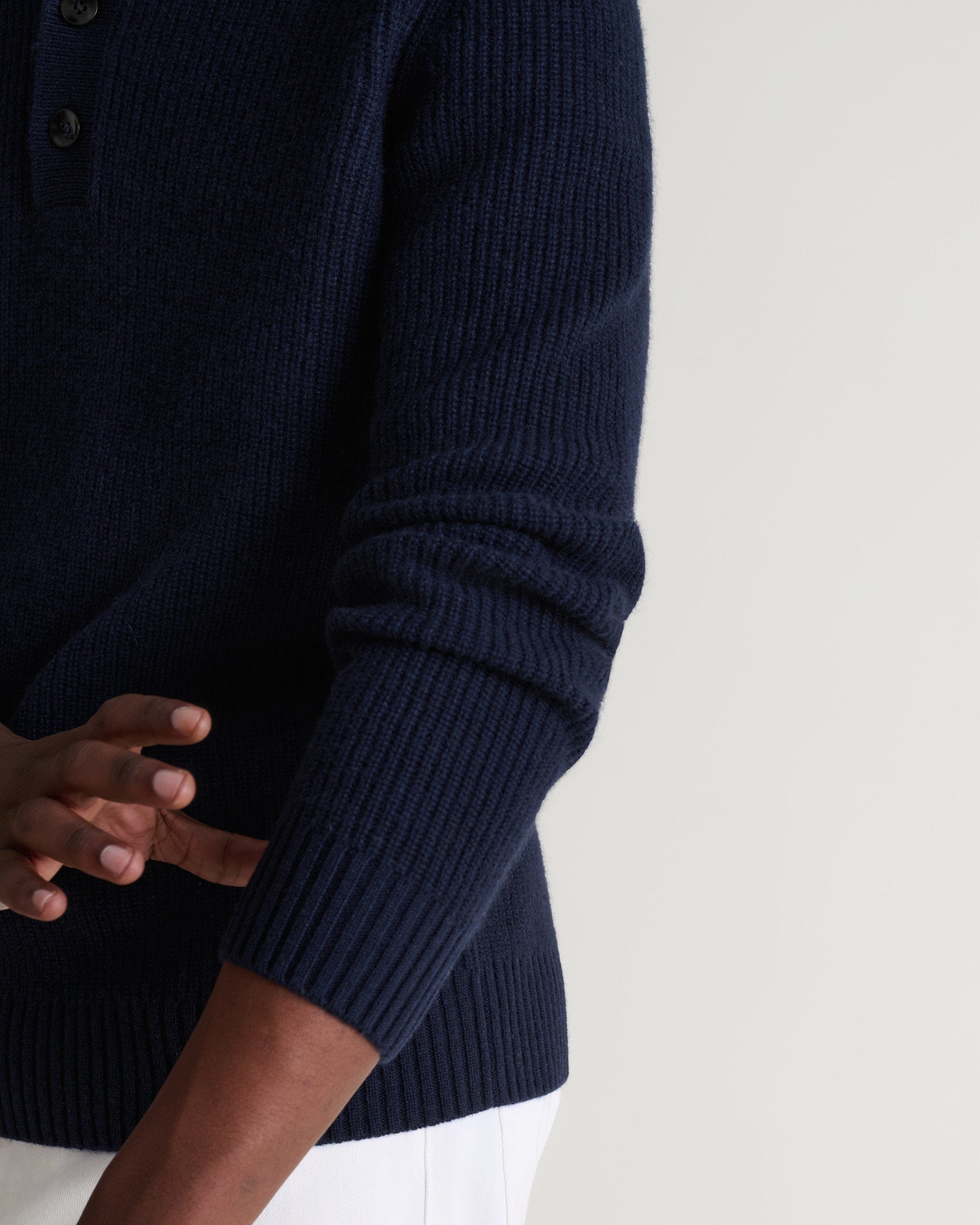 Image 6 of 6 showing man wearing Rise & Fall's indigio blue cashmere merino fisherman ribbed polo sweater. Close up of sleeve.