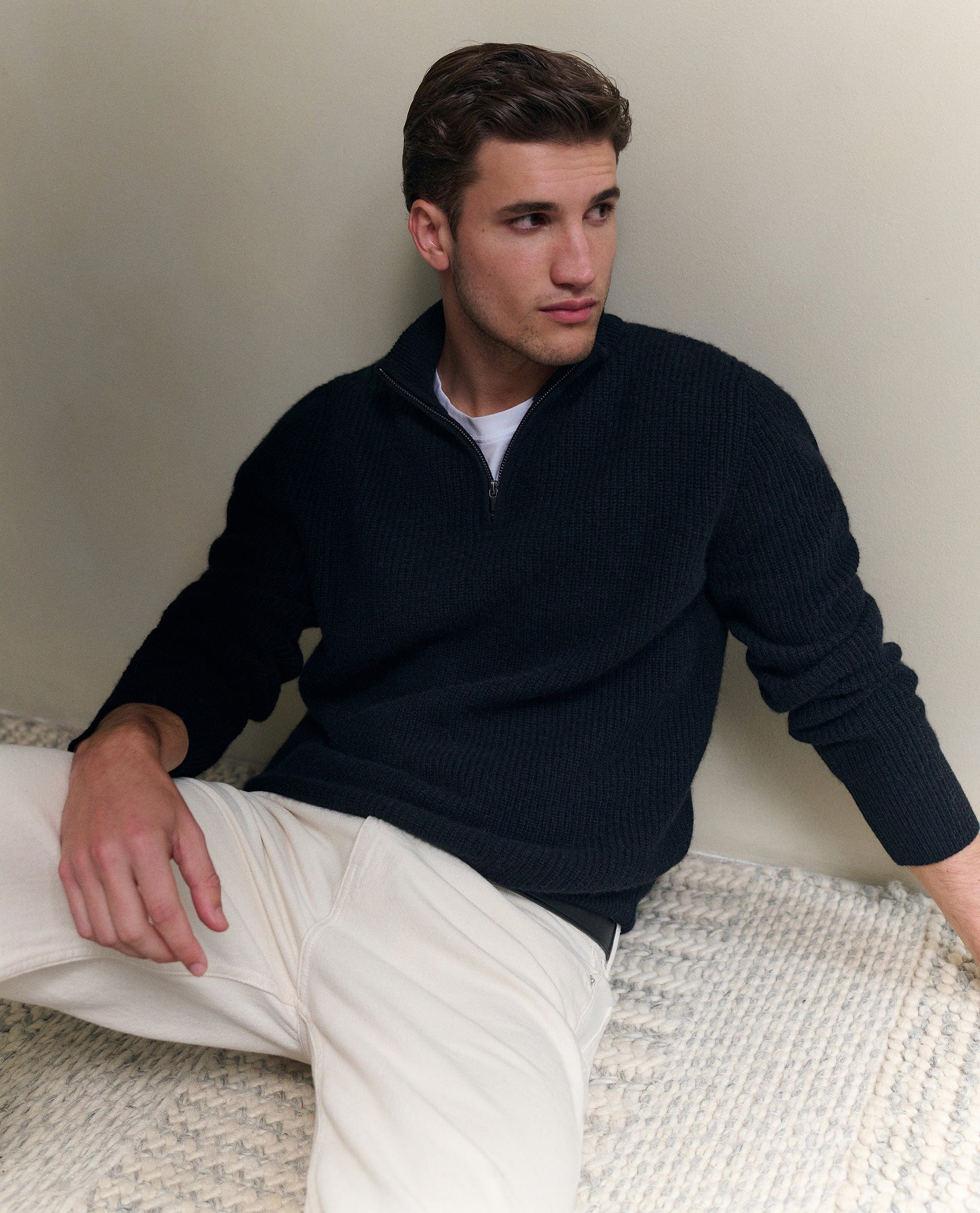 Image 6 of 6 showing man wearing Rise & Fall's Cashmere Merino Fishermans Rib 1/4 Zip Jumper in black.