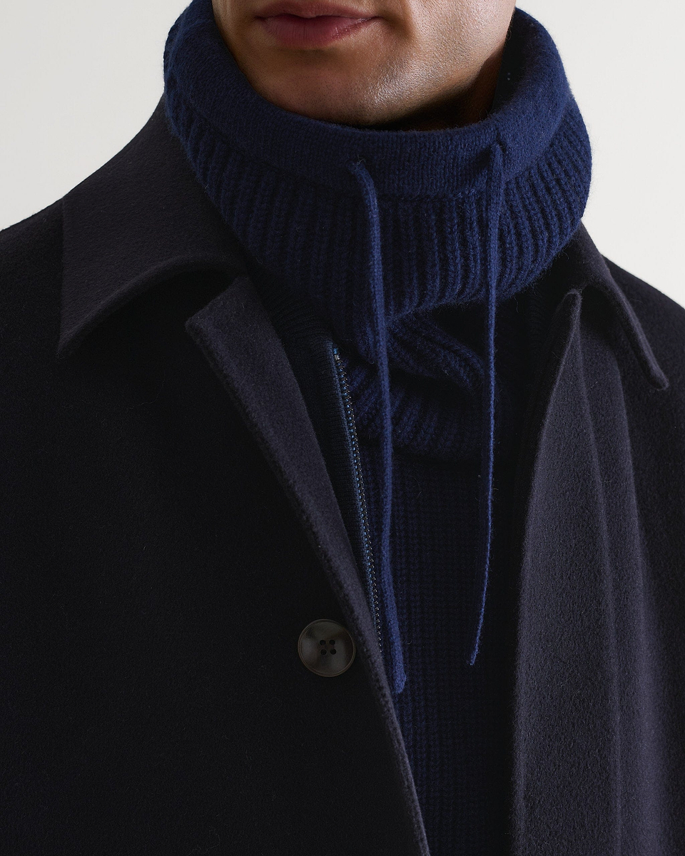 Close up of indigo cashmere merino drawstring snood worn with navy wool coat