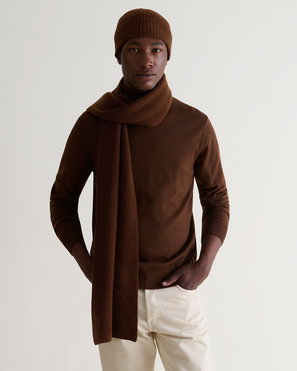 Man wearing burl brown cashmere merino ribbed beanie with matching coloured scarf and jumper and cream jeans